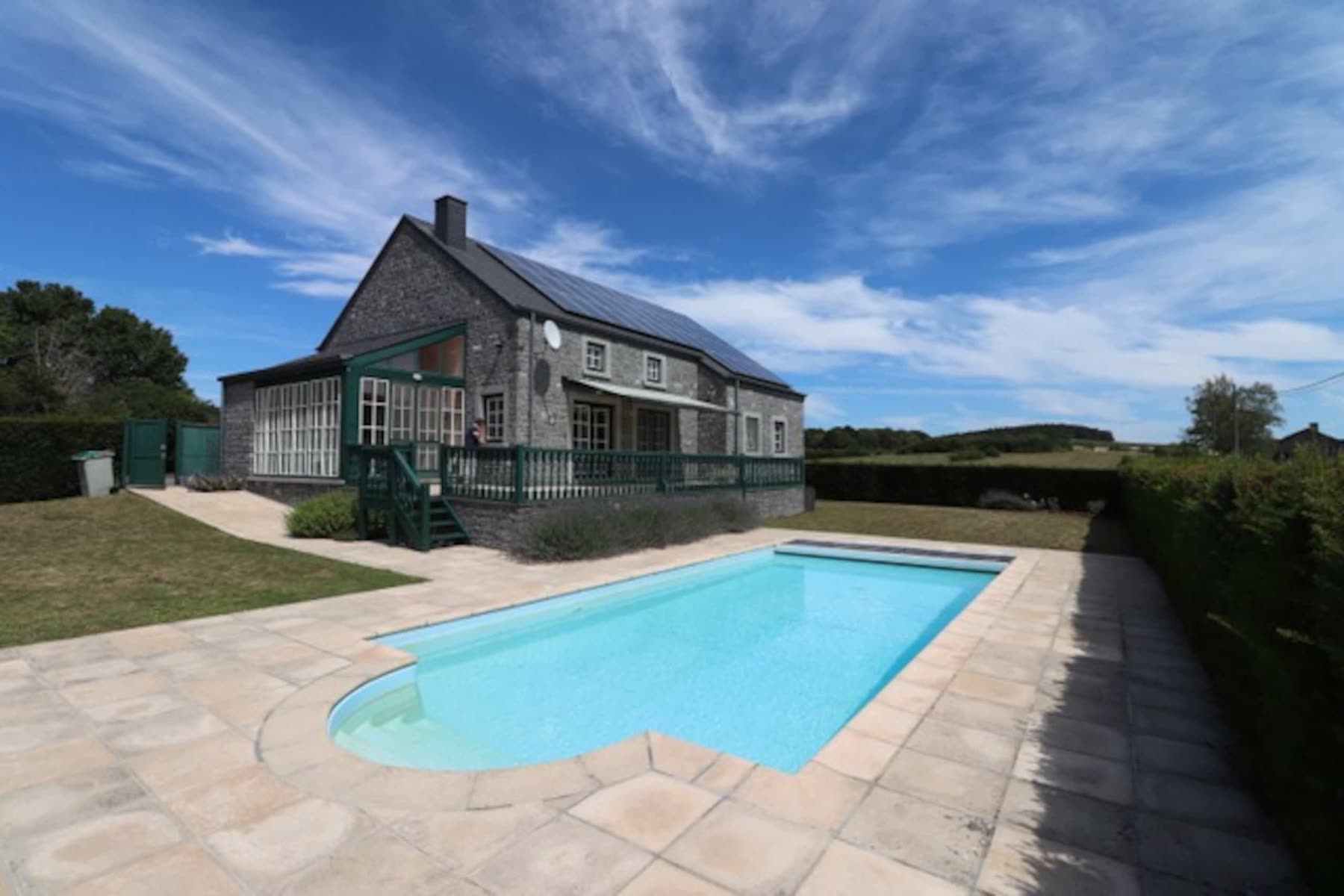 La piscine extérieure privée de La Porte de l'Ardenne, le long de la maison en pierre du pays